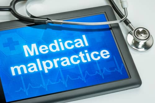 Boise medical malpractice lawyer concept, stethoscope and tablet reading medical malpractice